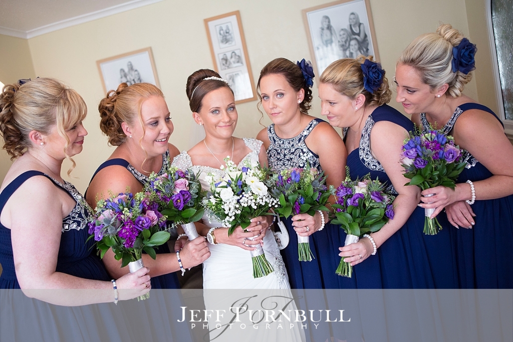 Bride and Her Bridesmaids together With Their Bouquets