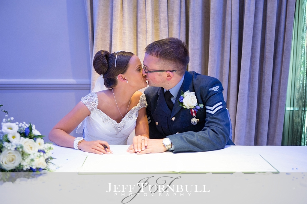 Bride and Groom Kissing after Signing the Register at Oakley Court Hotel