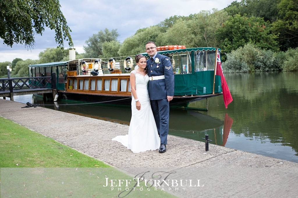 Bride and Groom by a green boat on the River Thames