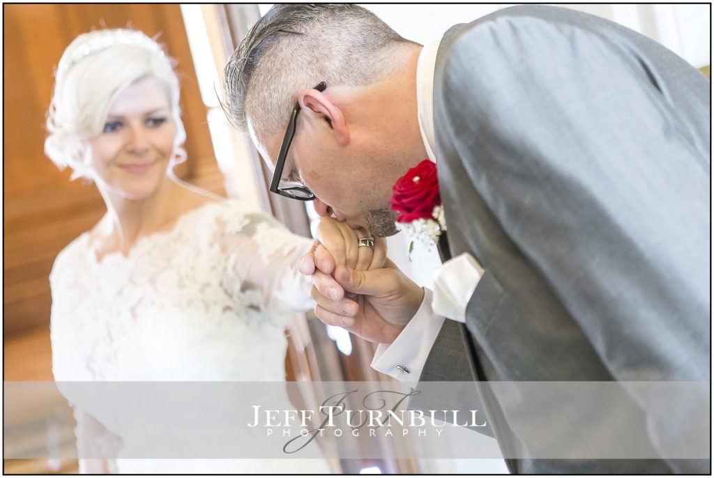 Groom kissing his Bride on the Hand
