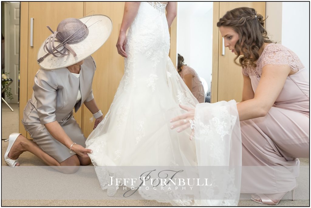 Bridesmaids help Bride get Ready