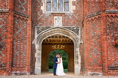 Bride and Groom Kissing by the Tower at Leez Priory