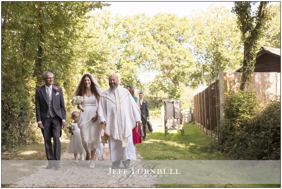 Bride and Dad walking up the lane