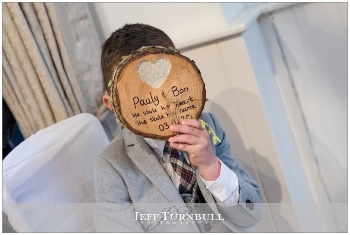 The pageboy hiding behind some wood