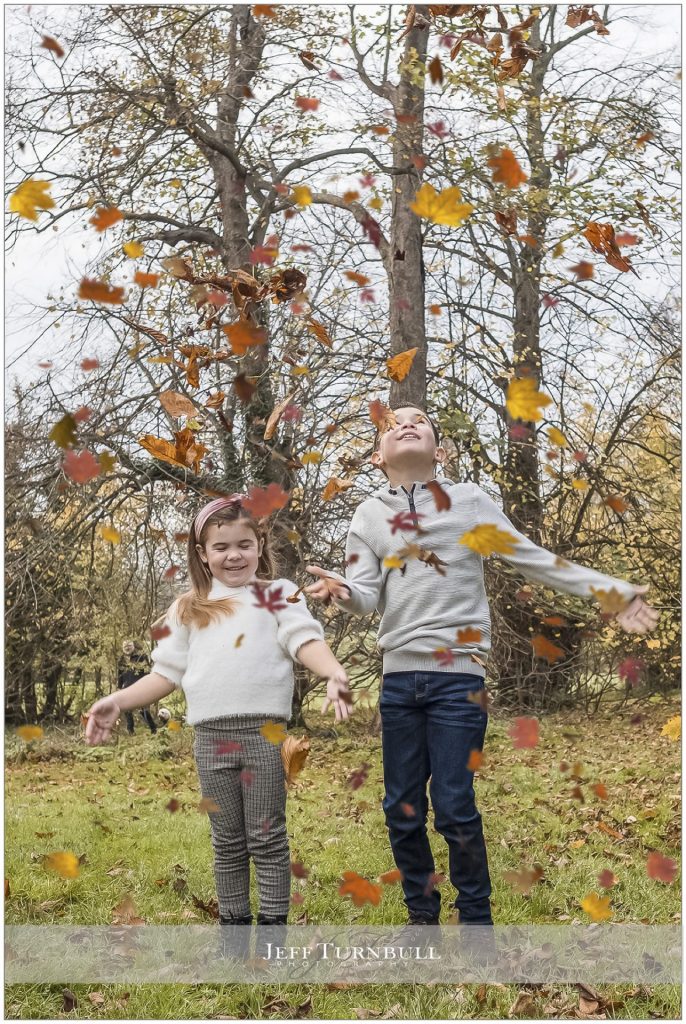 Young Boy and Girl throwing leaves