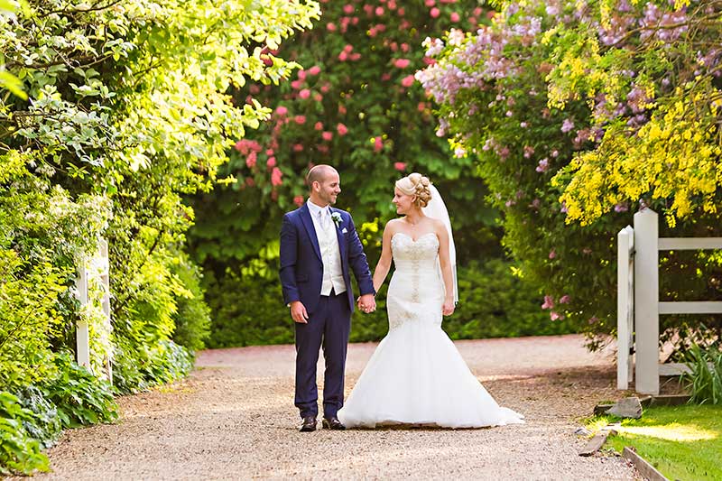 Bride and Groom Walking Holding Hands at the Reid Rooms