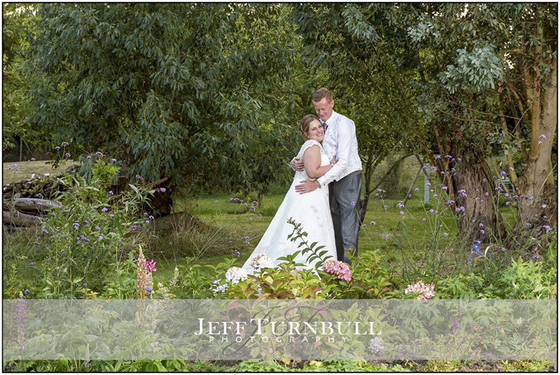 Bride and Groom Standing by the Lake at High House Essex Venue
