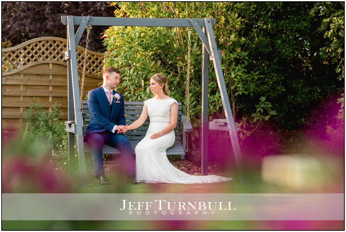 Bride and Groom Sitting on a Large Swing at Little Channels