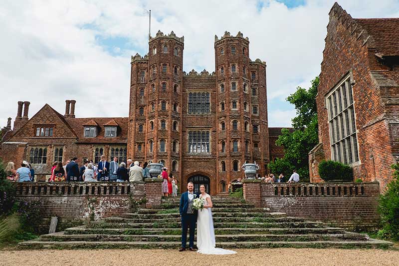 Bride and Groom in front of the Tower at Layer Marney Wedding Venue